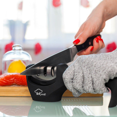 3-in-1 Professional Kitchen Knife Sharpener in use, sharpening a knife on a kitchen countertop.